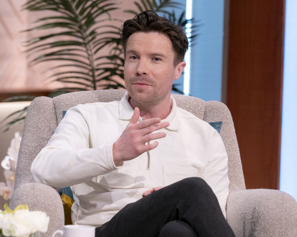 Man in white shirt sitting on sofa