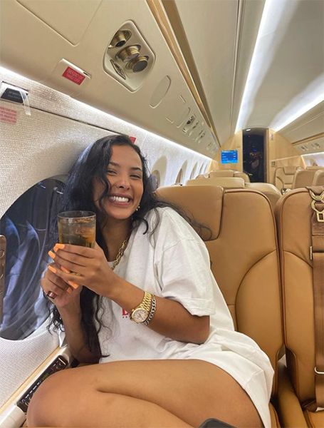 Maya Jama displaying legs on private jet