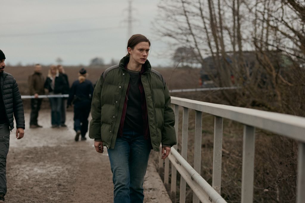 woman walking along bridge