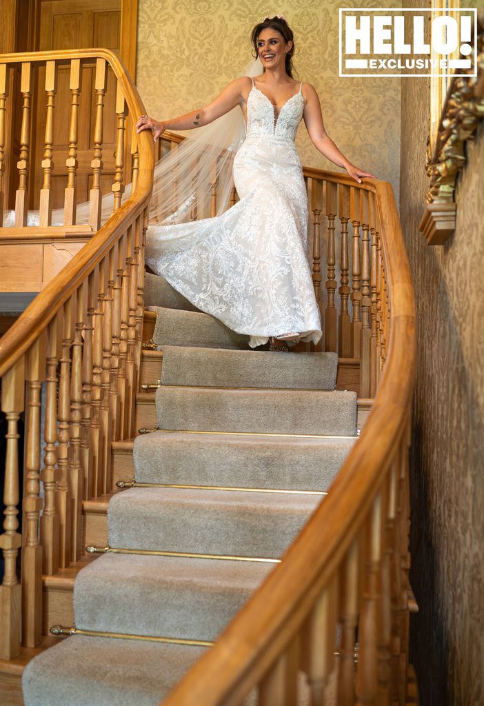 Emilie Cunliffe walking down the stairs in a wedding dress