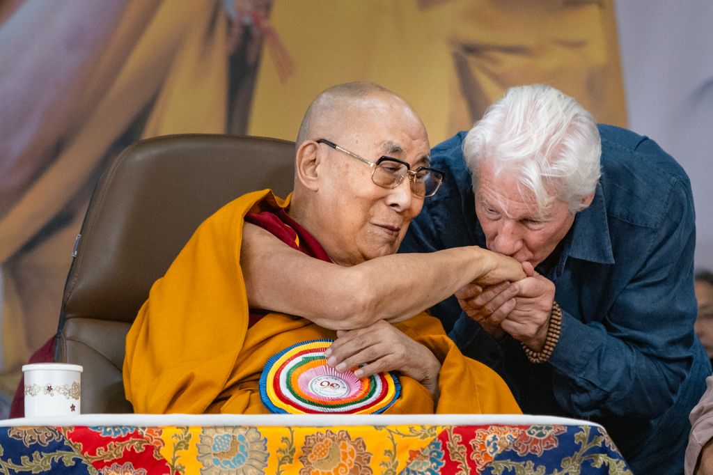 The Tibetan spiritual leader, the 14th Dalai Lama, receives a kiss on the hand from actor Richard Gere during his 90th birthday celebration on July 06, 2025 in Dharamshala, India.