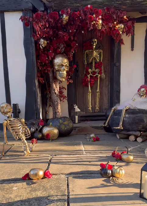 stacey's solomon's door decorated with red and gold skulls and roses