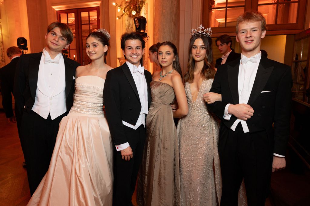 three young ladies in ballgowns with three young boys in white tie