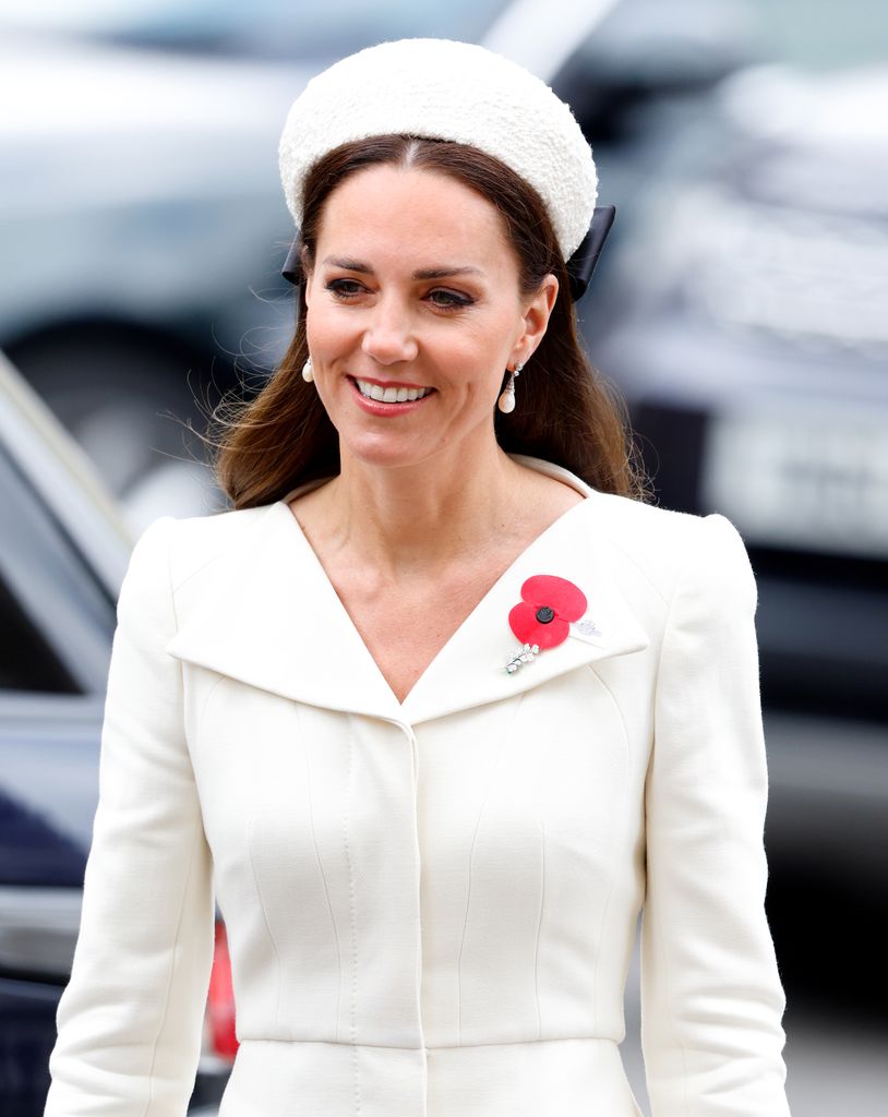 Catherine in white dress and headband waist up