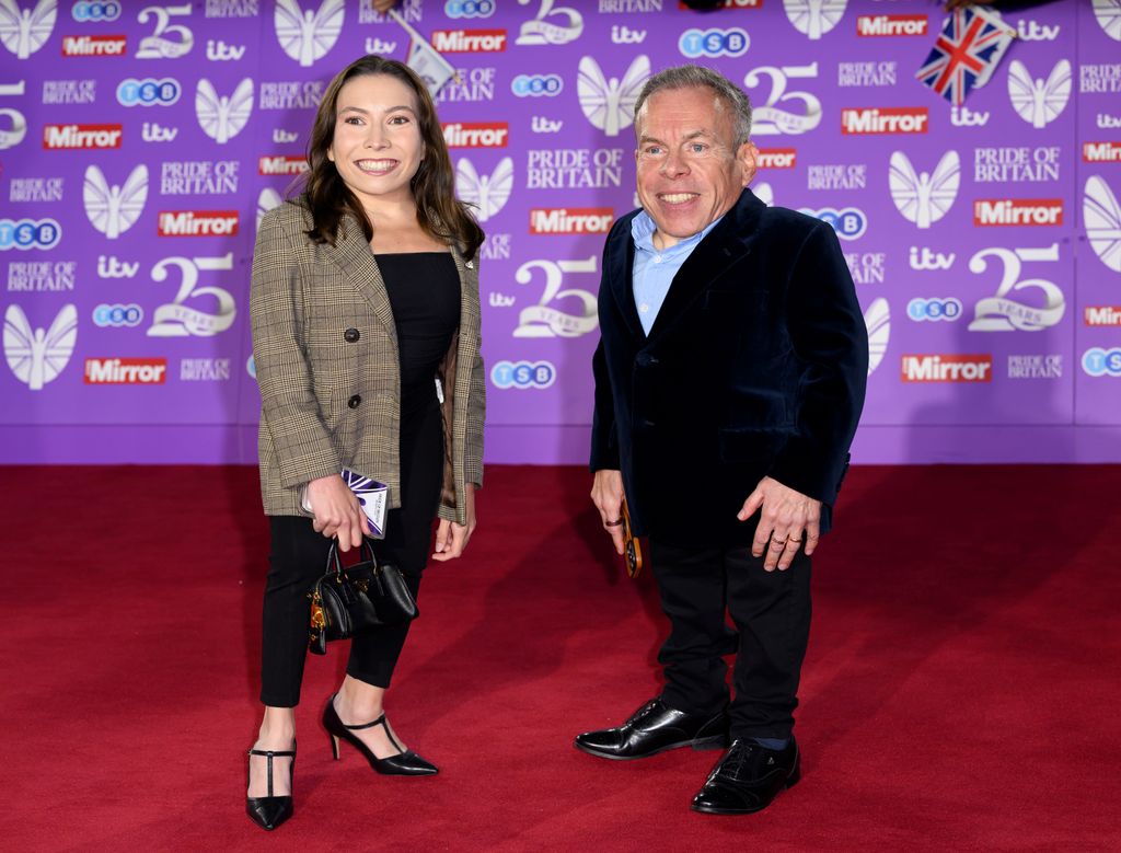 father and daughter posing on red carpet