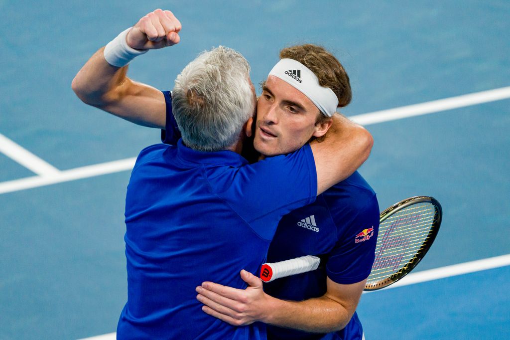 father and son celebrating on tennis court