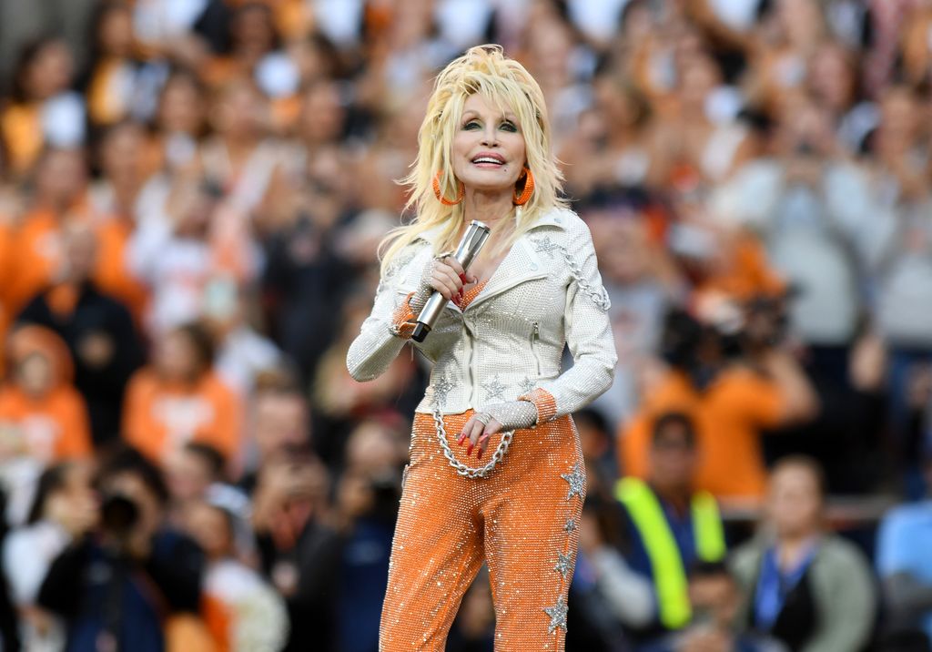 KNOXVILLE, TN - NOVEMBER 18: Dolly Parton performs during the college football game between the Georgia Bulldogs and the Tennessee Volunteers on November 18, 2023, at Neyland Stadium in Knoxville, TN. (Photo by Jeffrey Vest/Icon Sportswire via Getty Images)
