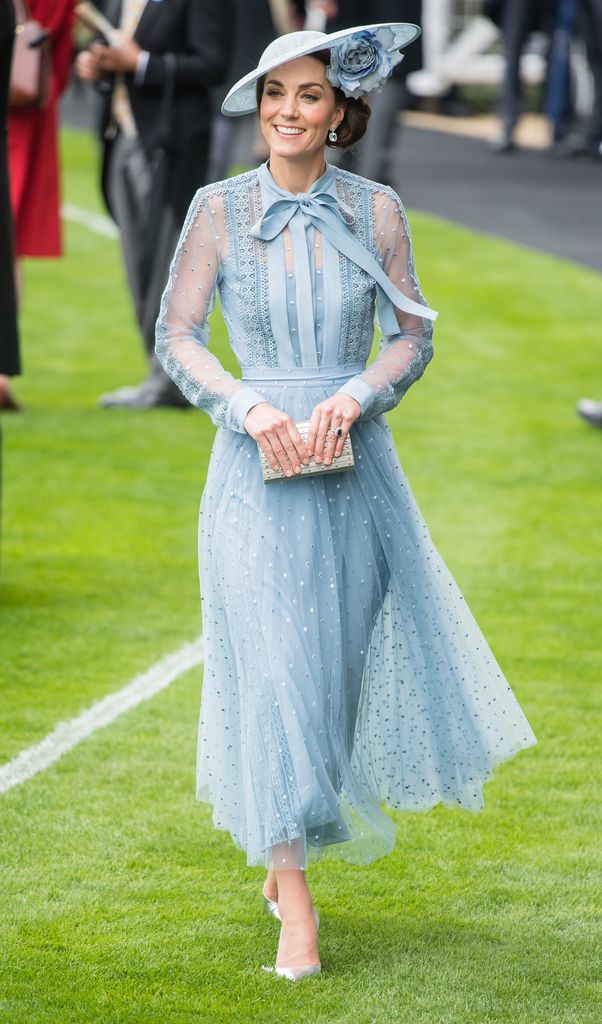 Kate in pale blue dress and hat