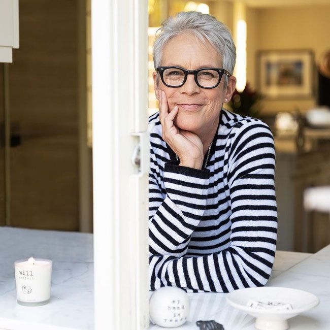 jamie lee curtis leaning forward on her white marble window sill