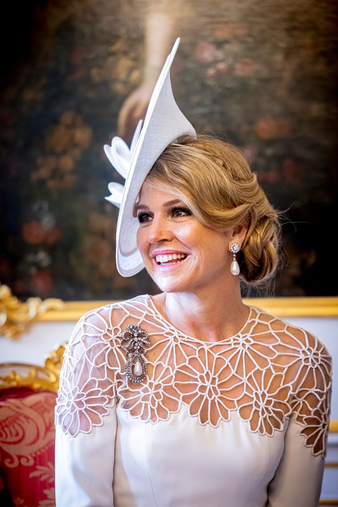 Queen Maxima wearing laser-cut dress and pearls