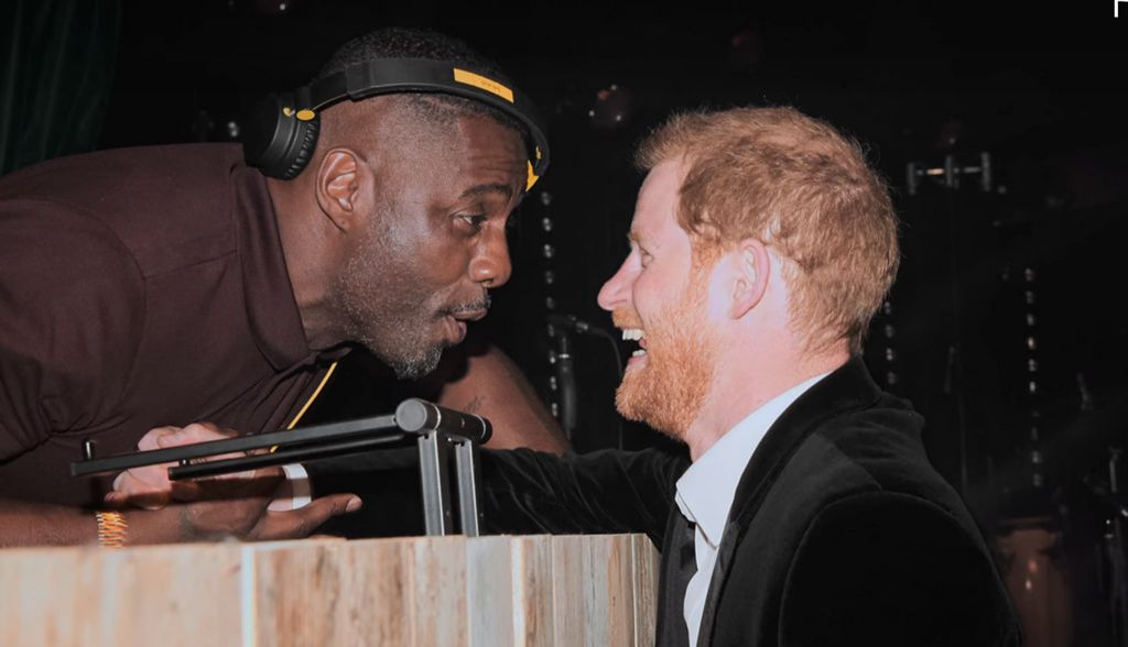 Idris in a casual polo top as he chatted to Prince Harry and DJ'd at the wedding