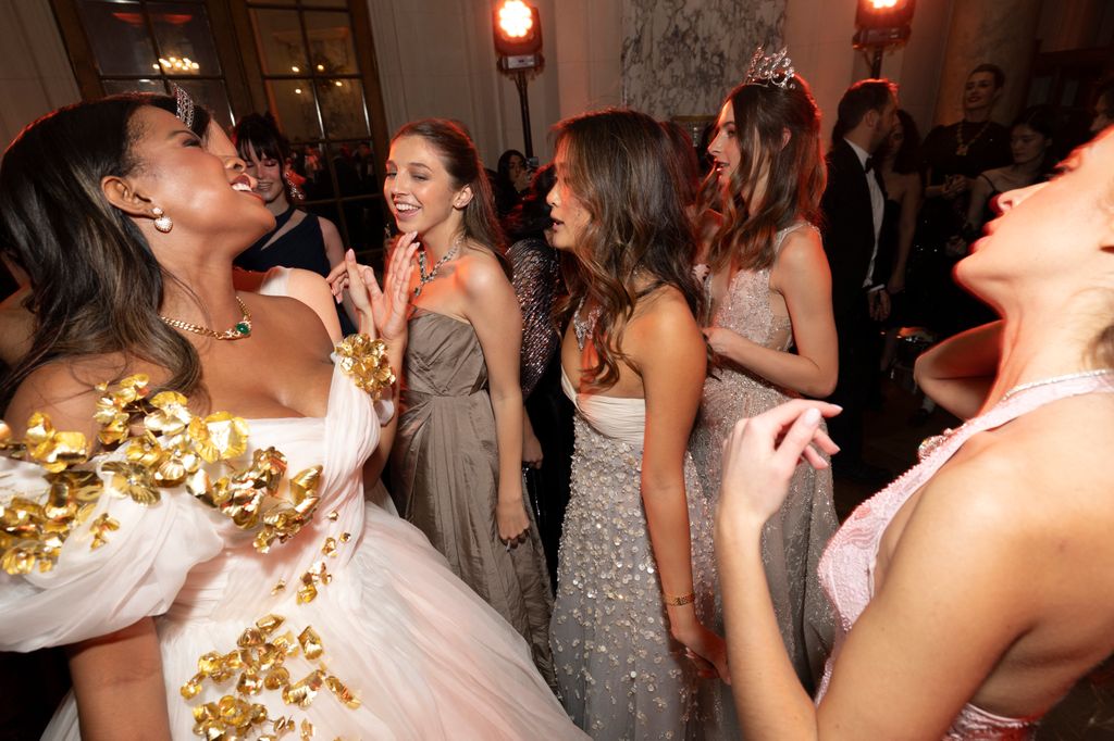 group of girls laughing in ball gowns