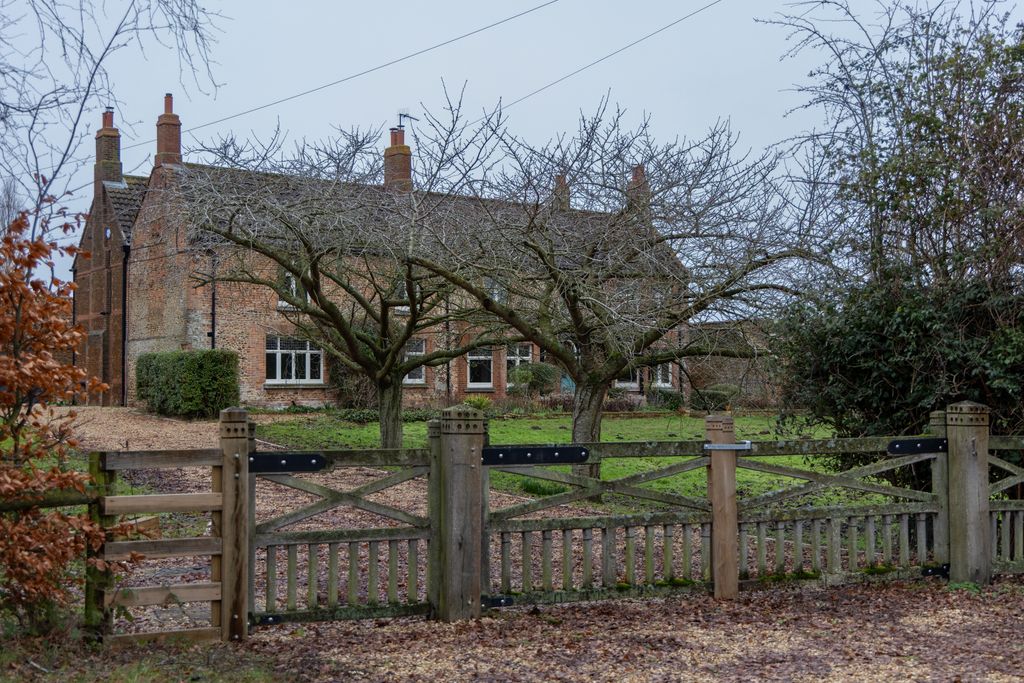 farmhouse with wooden gate and fence