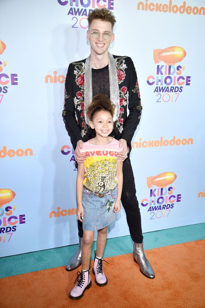 Machine Gun Kelly and Casie Colson Baker on orange carpet