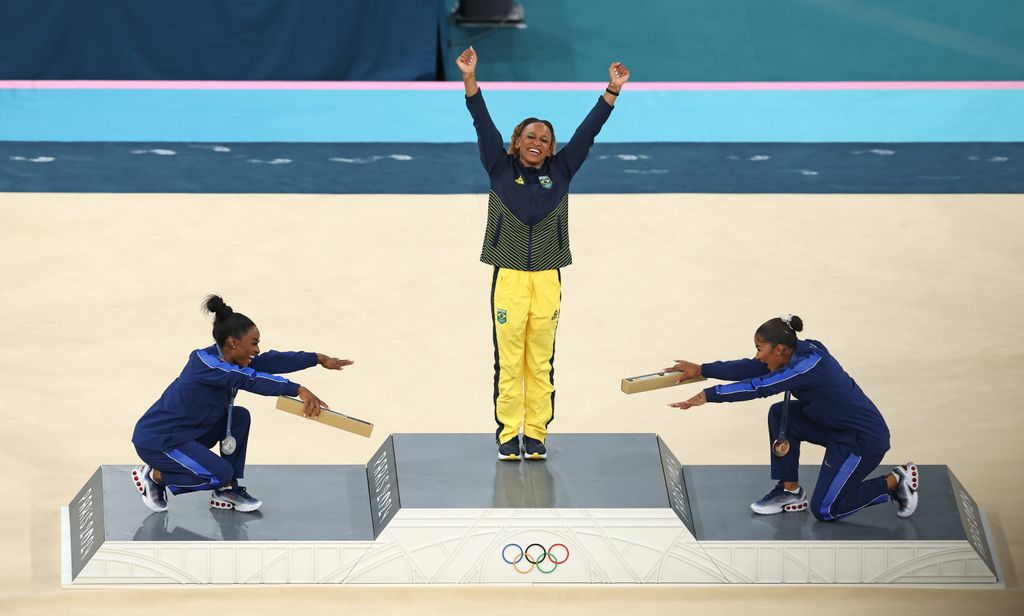 Gold medalist Rebeca Andrade (C) of Team Brazil, silver medalist Simone Biles (L) of Team United States and bronze medalist Jordan Chiles (R) of Team United States celebrate on the podium at the Artistic Gymnastics Women's Floor Exercise Medal Ceremony on day ten of the Olympic Games Paris 2024 at Bercy Arena on August 05, 2024 in Paris, France