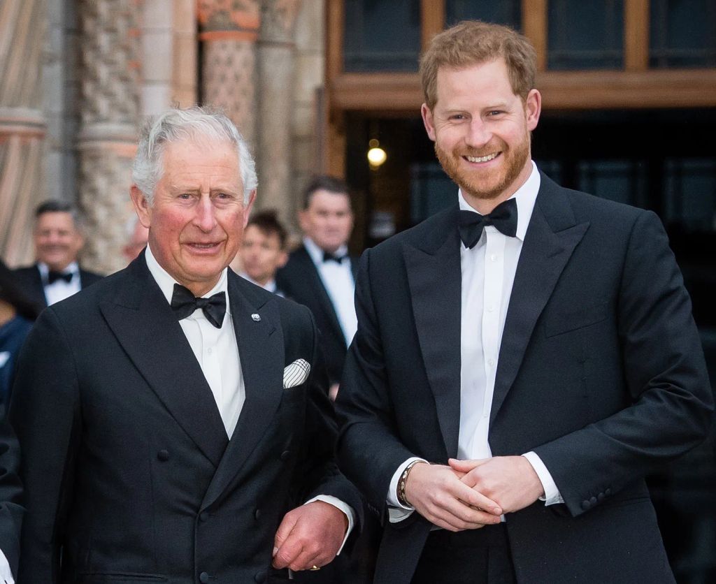 King Charles and Prince Harry wearing tuxedos posing for a photograph 