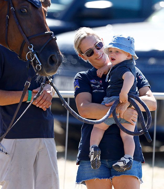 Zara Tindall lifts son Lucas up to see a horse at 2022 Festival of British Eventing