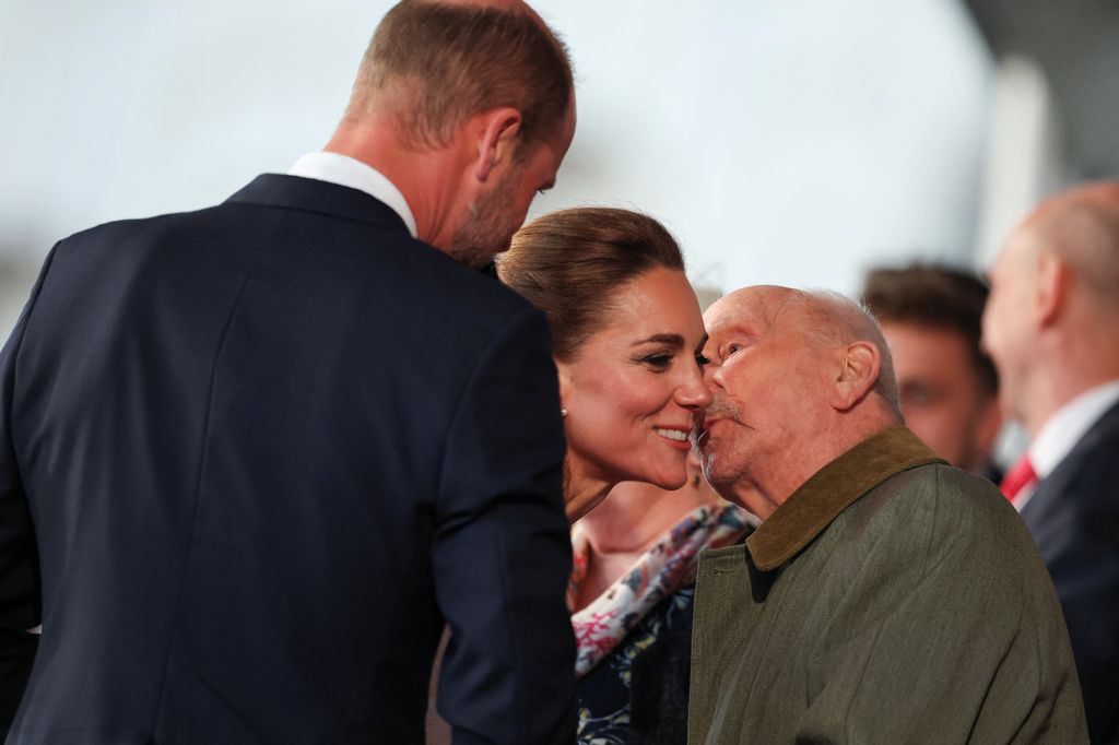 The Princess of Wales receives a kiss from veteran Harry Richardson