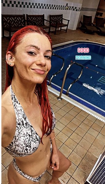 Dianne Buswell posing by an empty swimming pool