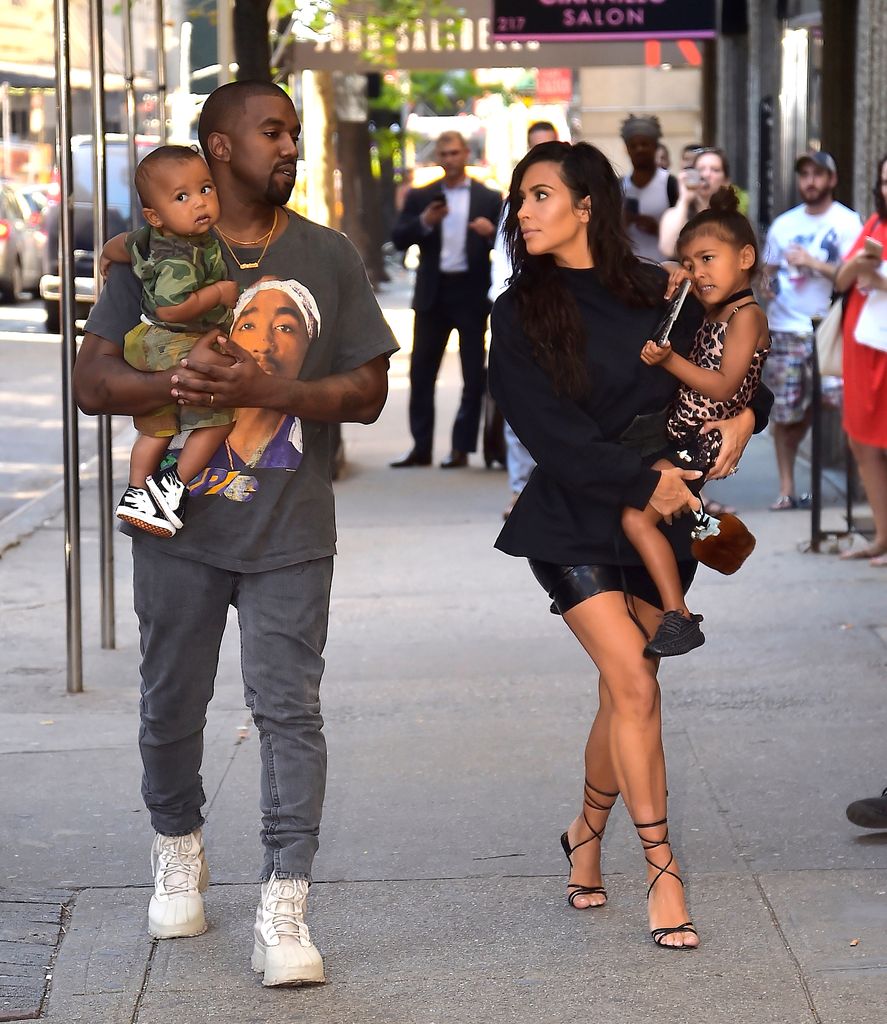 Kim Kardashian holding daughter North West with ex Kayne West holding their son