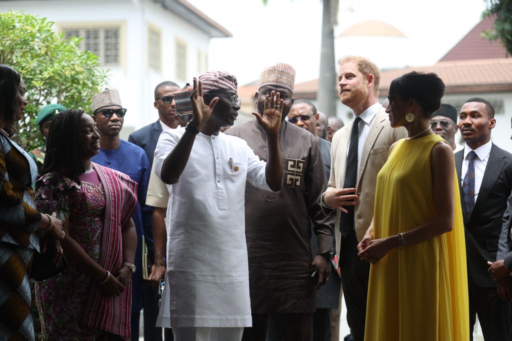 Lagos State Governor, Babajide Sanwo-Olu (3rdL), and Nigeria Chief of Defense Staff Christopher Musa (3ndR), welcome Britain's Prince Harry (2ndR), Duke of Sussex, and  Britain's Meghan (R), Duchess of Sussex, as they arrive at the State Governor House in Lagos on May 12, 2024 