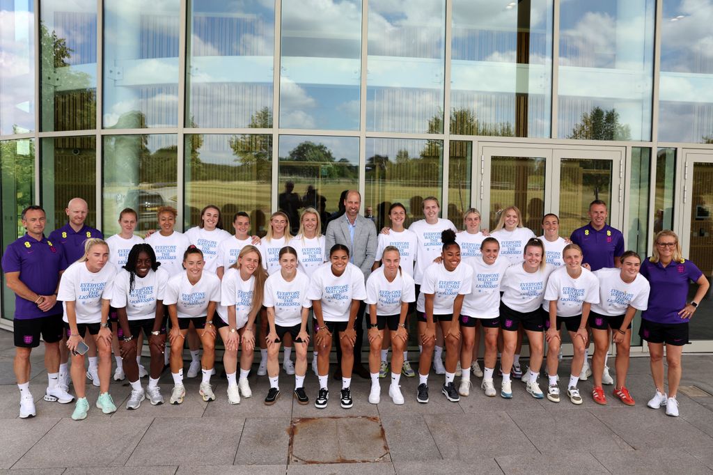 Britain's Prince William, Prince of Wales (C), Patron of The Football Association, poses for a group photo with the players and staff during a visit to the "Lionesses", England's women's football team at St George's Park,