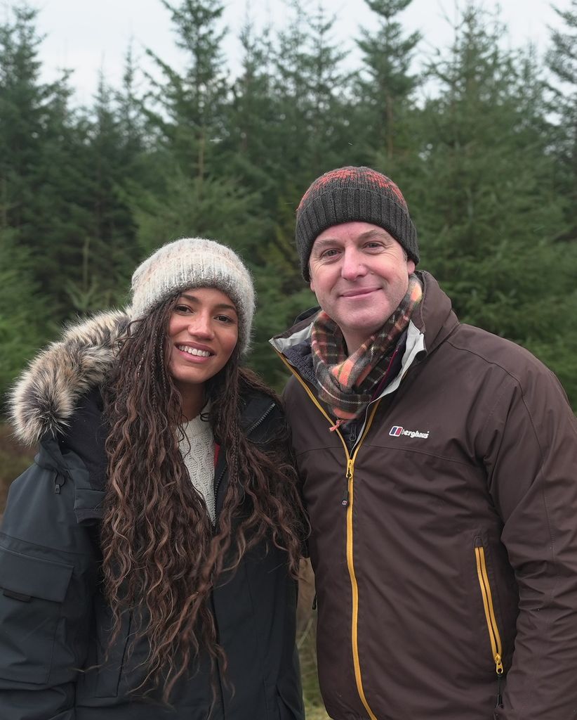 Vick Hope smiling with Matt Baker in a forest
