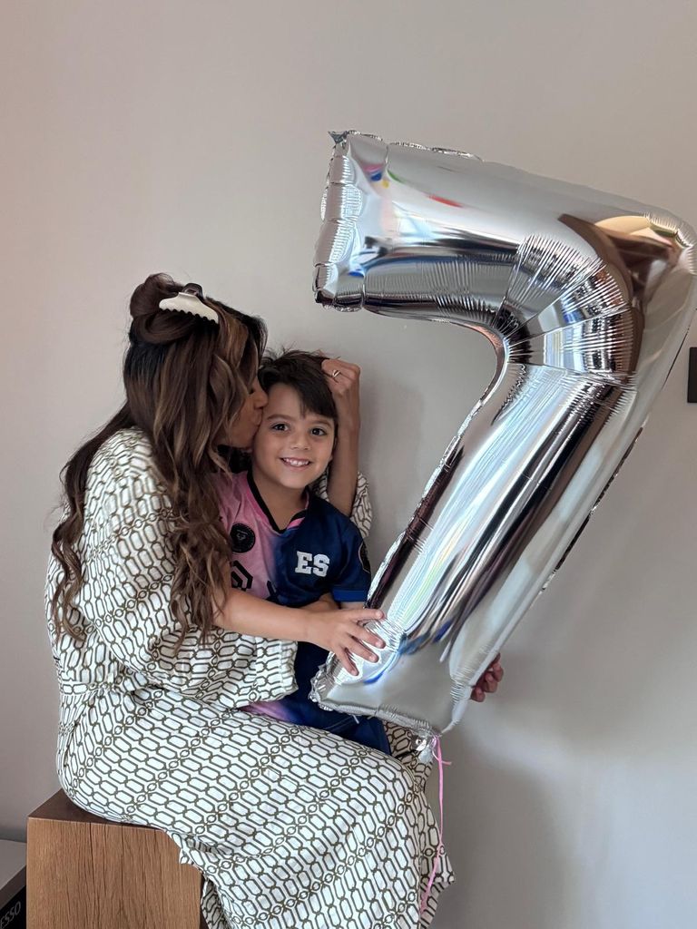 eva longoria kissing son holding up '7' balloon