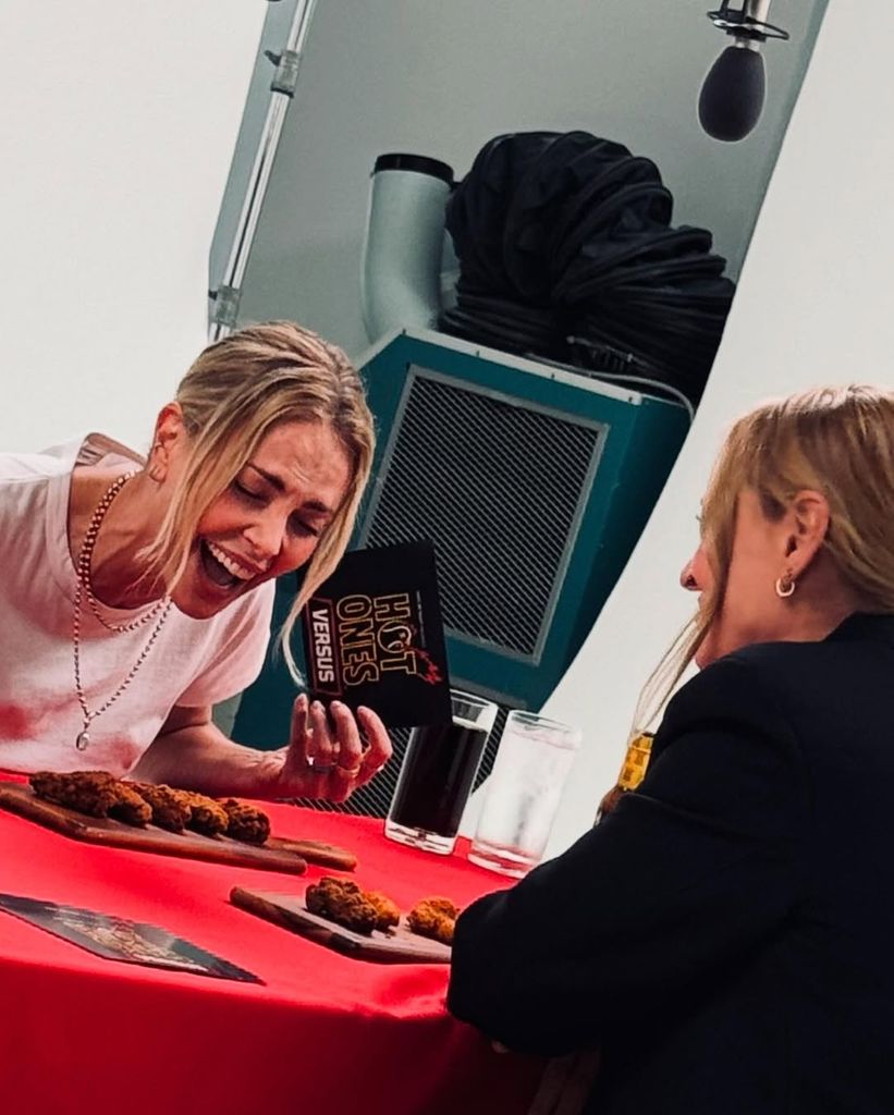Charlize Theron and Uma Thurman captured during a Hot Ones interview at the Netflix Upfront, shared on Instagram