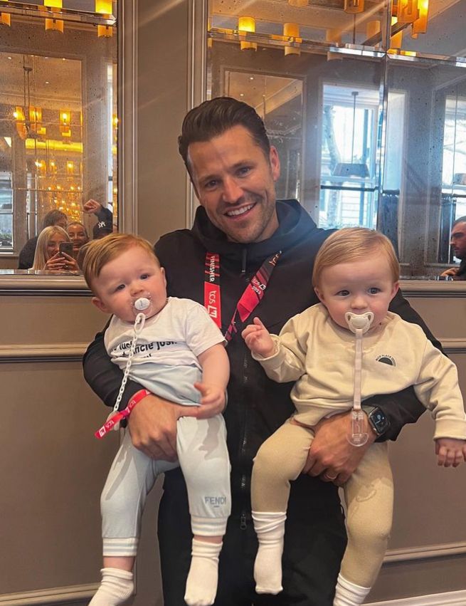 Mark Wright holding two babies