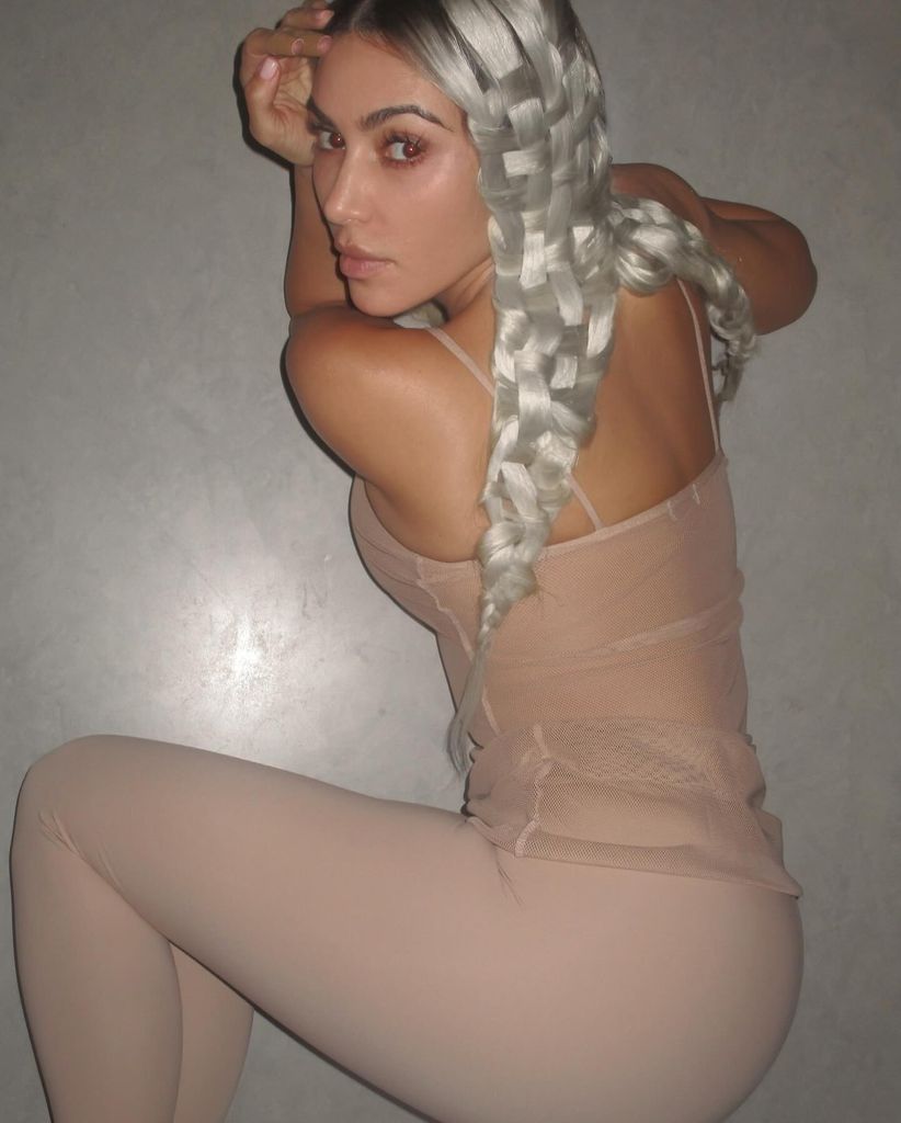 Kim Kardashian lying on the ground with braided hair