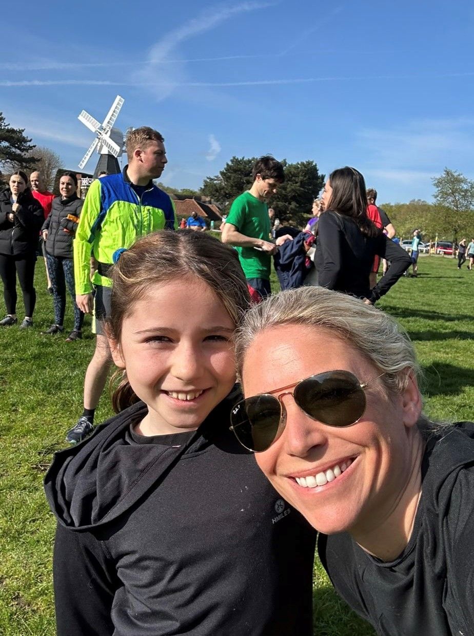 Woman and daughter smiling after running 