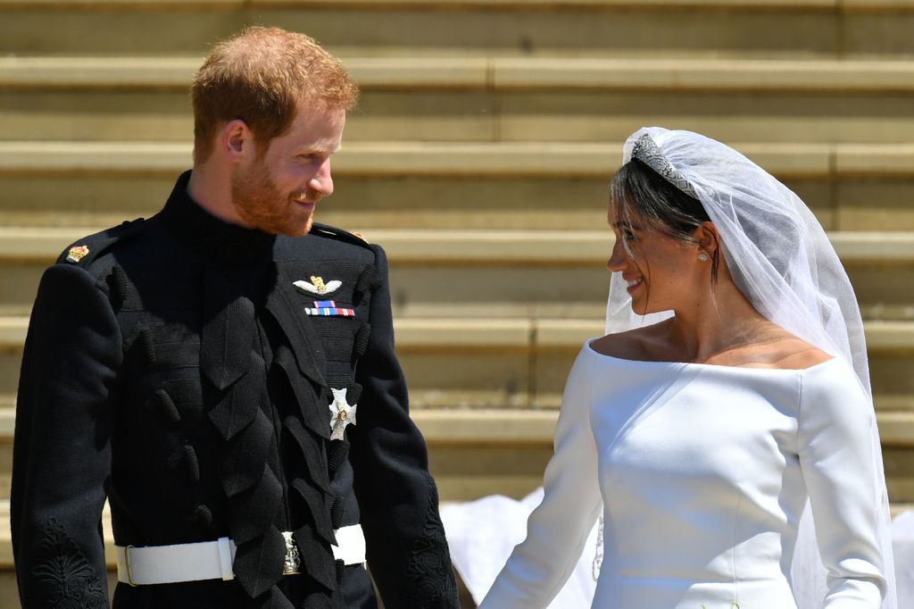 Prince Harry smiles at his new wife the Duchess of Sussex on the steps of St George's Chapel