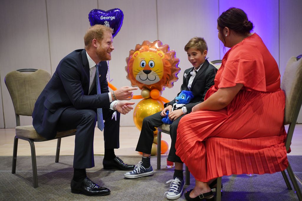 The Duke of Sussex speaks to George Hall and mum Hollie Pearson