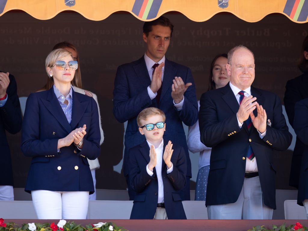 Princess Charlene and Prince Jacques clapping in sunglasses