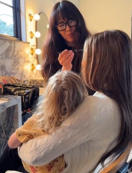Jessica Biel in make up chair with son Phineas on her lap