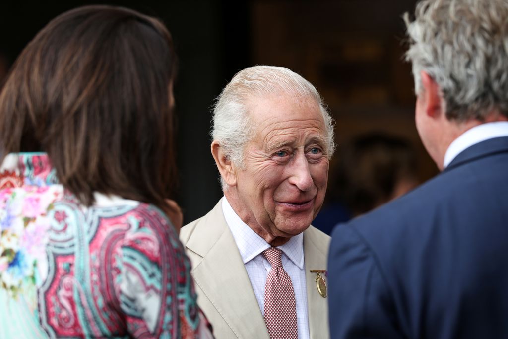 British King Charles speaks with members of staff and club members of the Jockey Club Rooms on July 22, 2025 in Newmarket, England