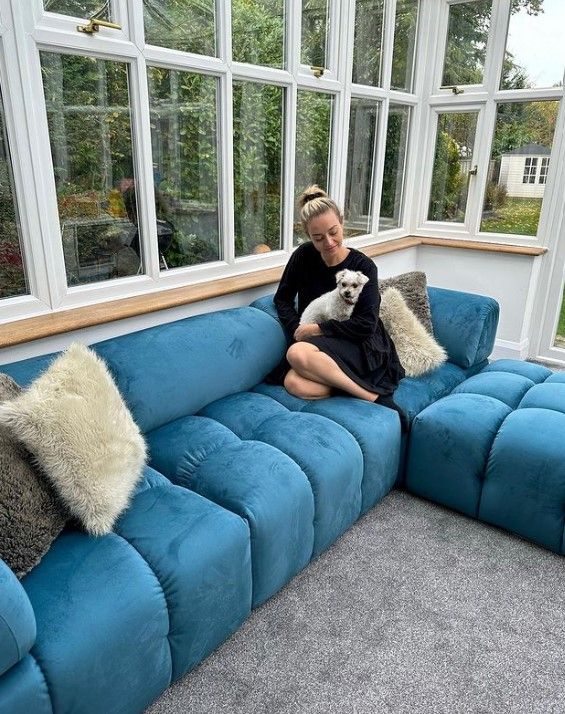 kelsey parker on blue sofa with dog