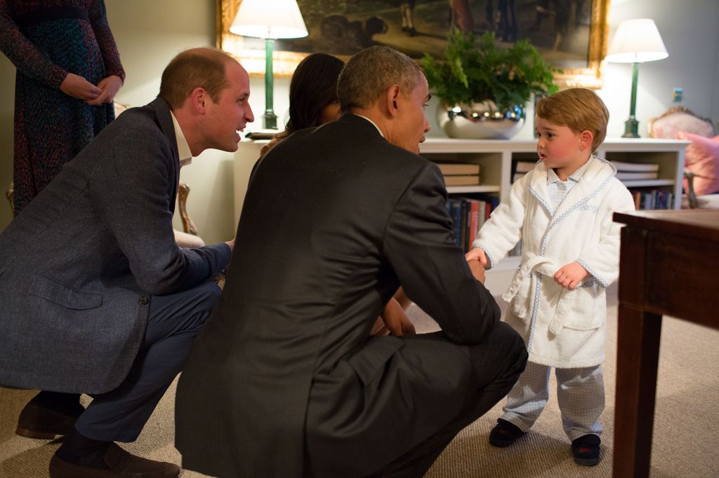 In this handout provided by The White House, President Barack Obama, Prince William and First Lady Michelle Obama talks with Prince George at Kensington Palace on April 22, 2016 in London, England.