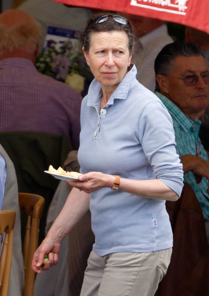 Princess Anne holding a plate of food