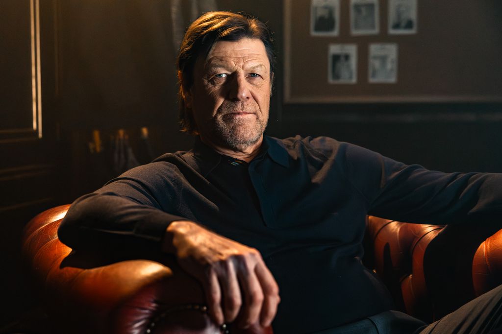 man sitting in leather arm chair