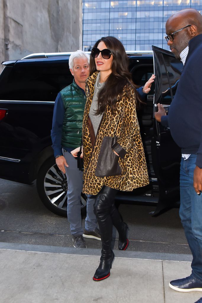 Amal stepping out of car in leopard print coat 
