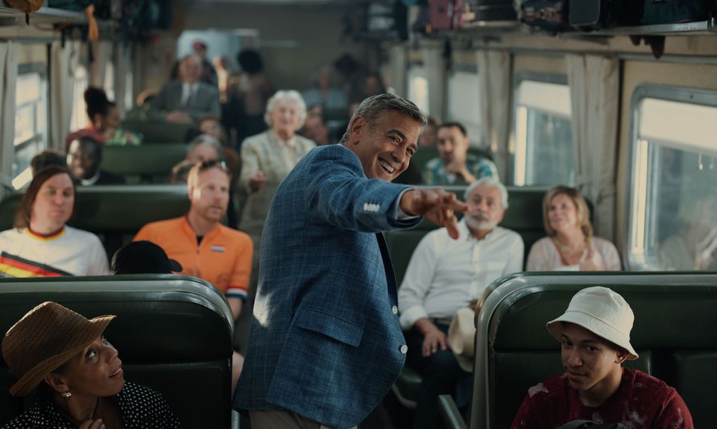 Man standing in aisle of busy bus