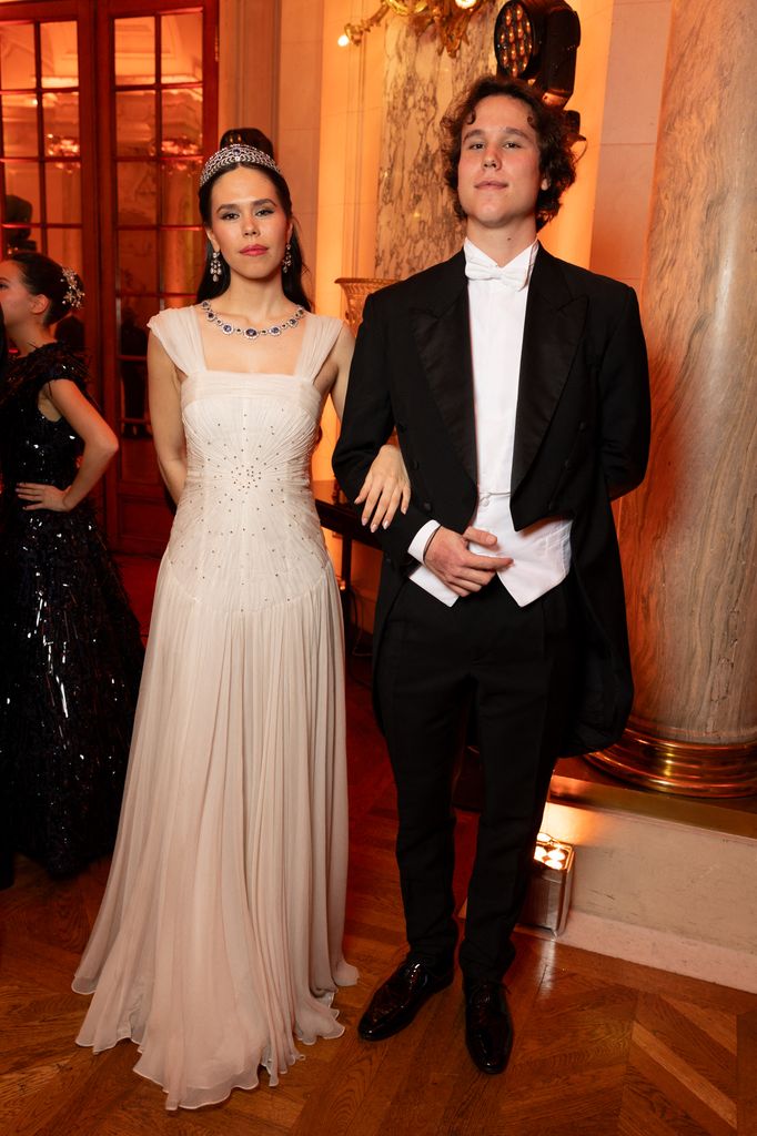 Gabrielle Janssens de Balkan in white gown with her cavalier