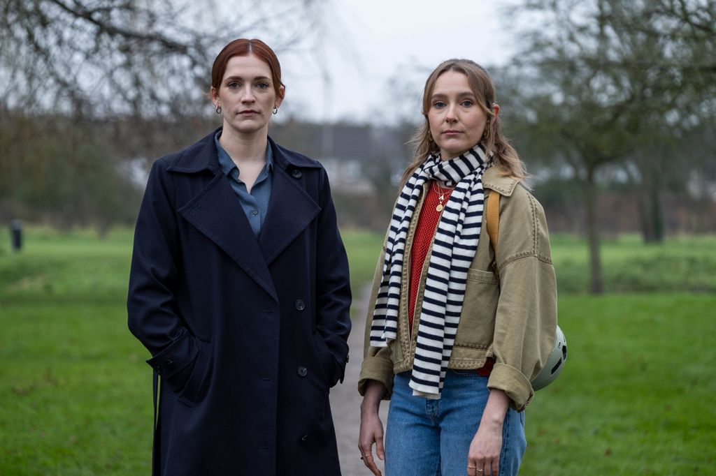 two women standing in park