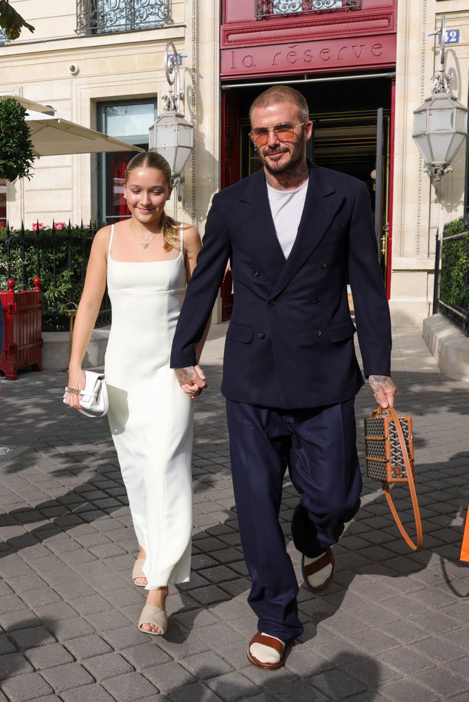 Harper wore a white dress while holding hands with David Beckham in a navy suit. She looked elegant and youthful, embodying a chic, timeless Parisian style.