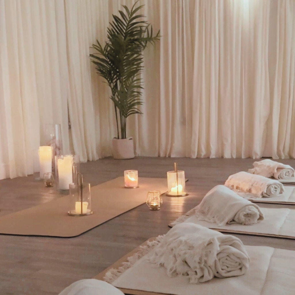 Candlelit room with mats and blankets 