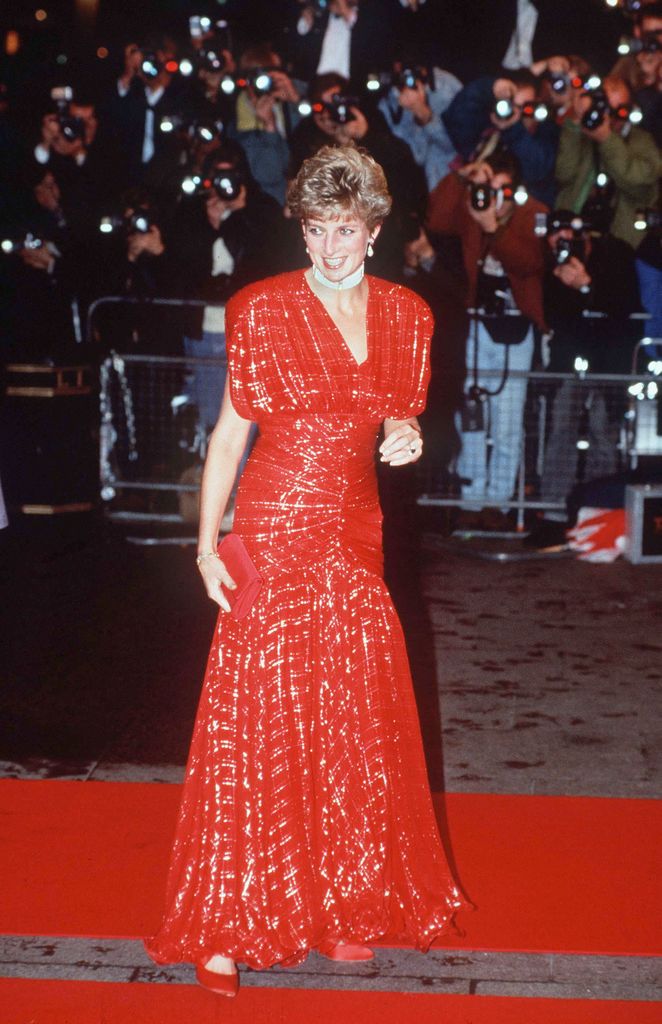 LONDON, UNITED KINGDOM - NOVEMBER 18:  The Princess Of Wales Attending The Premiere Of 'hot Shots' In Leicester Square, London Being Photographed By A Big Press Corps Of Photographers. Bright Red Glitter Dress Designed By Fashion Designer Bruce Oldfield  (Photo by Tim Graham Photo Library via Getty Images)