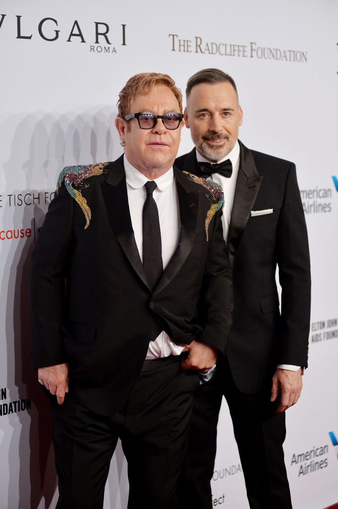 Sir Elton John in an embellished suit with husband David Furnish in a bow tie