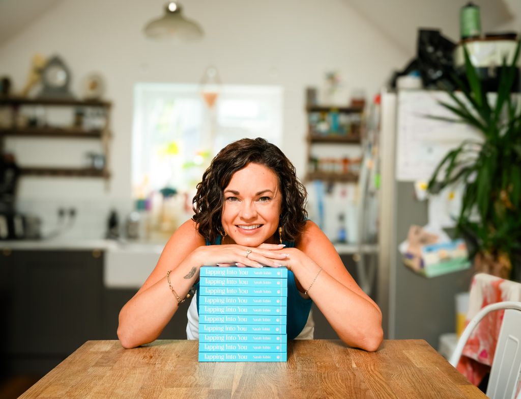 Sarah poses with her book Tapping Into You